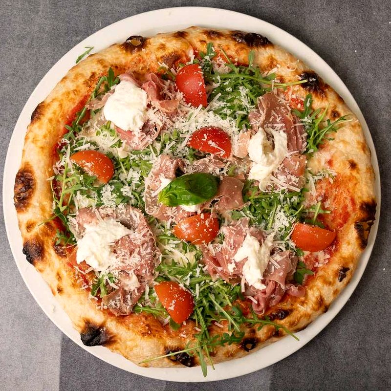 Parma pizza with Parma ham, rocket and parmesan shavings